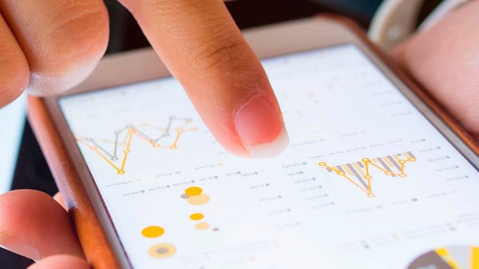 Recycling Audit Tool, photo showing a person scrolling a screen with graphs.