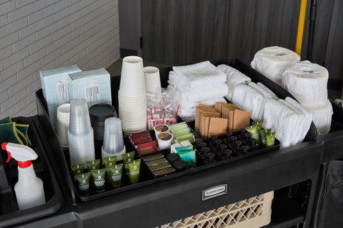 Cleaning supplies on top of housekeeping cart