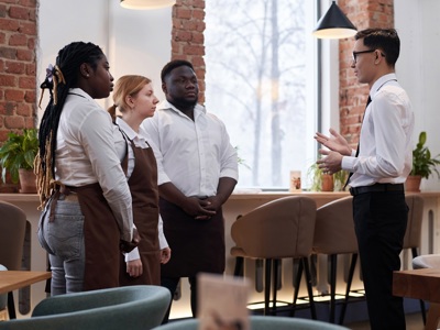Restaurant Manager Talking Waiting Staff